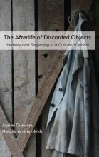 Cover of Guruianu and Andrievskikh’s The Afterlife of Discarded Objects, featuring a photo of a coat handing from a weathered, wooden door.