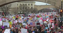 Image of crowd of protesters holding signs