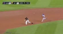 Baseball player is in a rundown between second and third base.