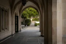Corridor in front of college building under arches.