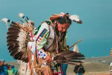 A Native American man in a ceremonial performance.