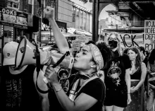 A girl with a megaphone participating in a protest